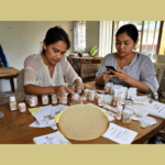 2 Filipina women working on labeling their products,